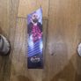 The item shown is the WWE Elite Collection Series 86 SummerSlam Seth Rollins action figure by Mattel, featuring his pink and black ring gear, TrueFX facial detailing, and themed accessories. Image 2