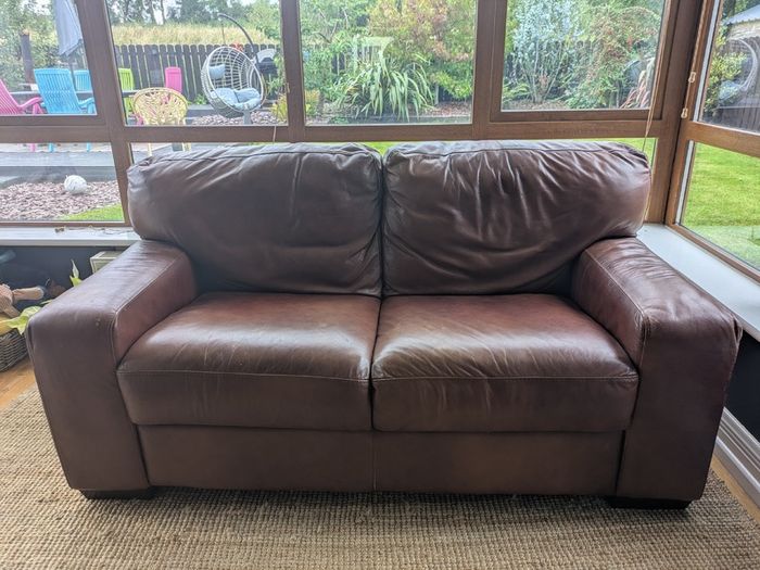 Brown faux-leather two-seater sofa