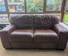 Brown faux-leather two-seater sofa