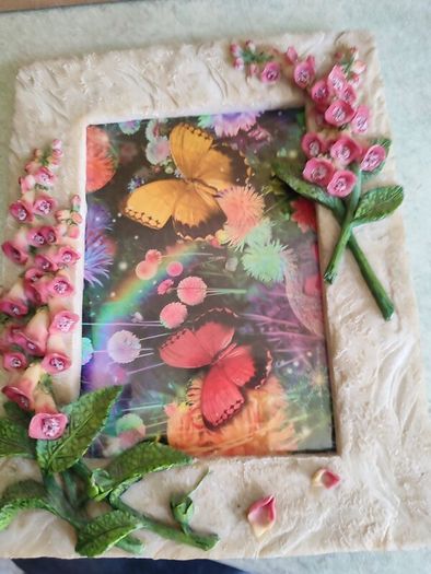 BUTTERFLIES picture framed in stone finish frame edged with flowers.