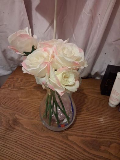 Artificial pink roses and vase
