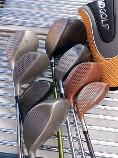 A selection of golf clubs and bags. All right handed clubs.