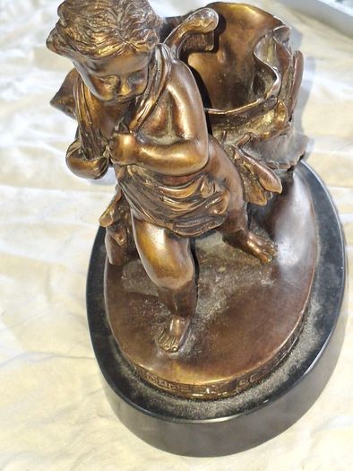 Bronzed Winged Cherub putto open seashell or leaf-shaped vessel with a scorpion like tail.