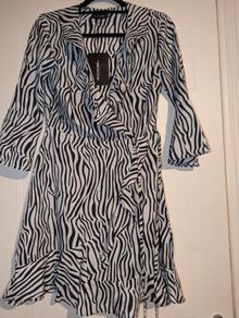 Perfect for Summer. black Zebra Print Wrap Tea Dress from Pretty Little Thing