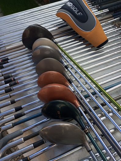 A selection of golf clubs and bags. All right handed clubs.