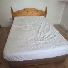 Small double bed with headboard and mattress