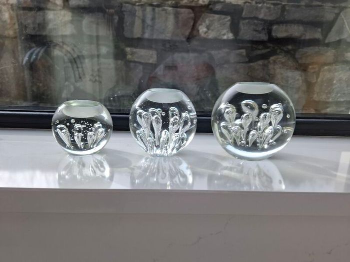 3 x cylindrical glass candle holders.