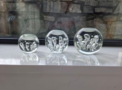 3 x cylindrical glass candle holders.
