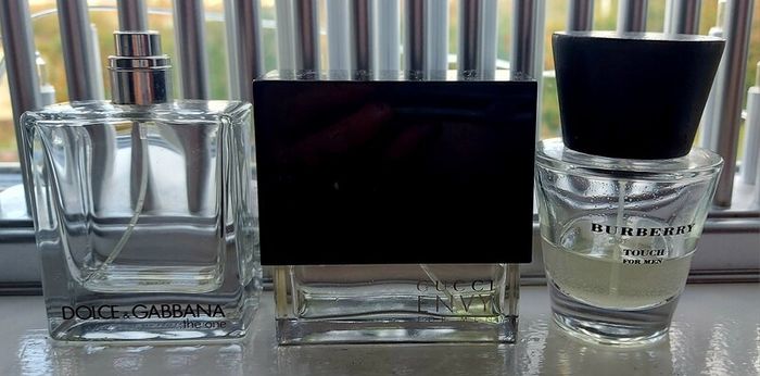 Three empty fragrance bottles
