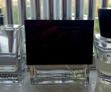 Three empty fragrance bottles