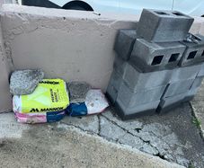 Brand new bricks and bran new bags cement