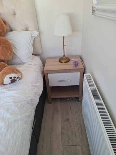 Timer and white wardrobe and bedside locker
