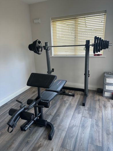 Home Gym Equipment: Adjustable Weider Gym Bench, Olympic bars, and Rubber Weights
