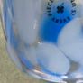 A hand-blown blue and white swirl art glass piece Small glass bowl with sticker say The phrase "EVERY PIECE IS UNIQUE" circles the clover. Image 4