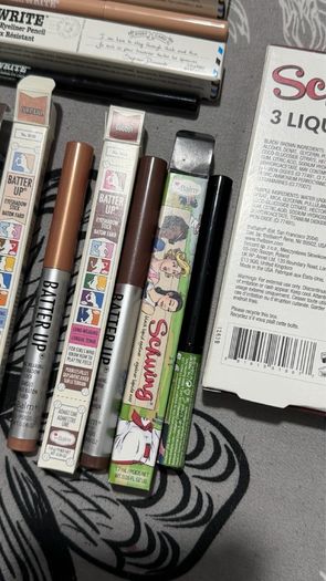 The balm tinted brow gel, clear brow gel, white, black eye pencils, liquid eyeliners