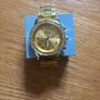 Gold coloured watch with diamonds around the face Image 4