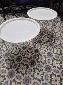 Set of two white round side tables