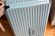 Big blue suitcase with 5 wheels