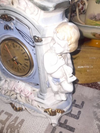 Porcelain Mantel Clock with Two Cherubs and Two Doves on top, and floral accents, Postage Available