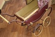 Antique Burgundy Doll's Pram, Manufactured by Walker around the 1940s, It features a Coach-Built Style Carriage with distinctive Wire-Spoke Wheels and Hard Rubber Tires Collection Only