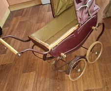 Antique Burgundy Doll's Pram, Manufactured by Walker around the 1940s, It features a Coach-Built Style Carriage with distinctive Wire-Spoke Wheels and Hard Rubber Tires Collection Only
