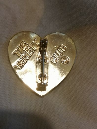 the variety club child's face brooch.