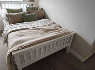 Small double white wooden bed