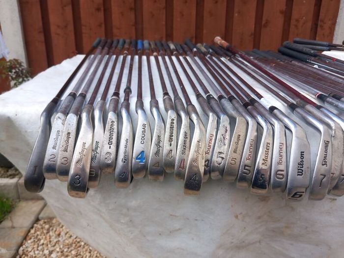 A selection of Golf clubs. Bags and golf balls.