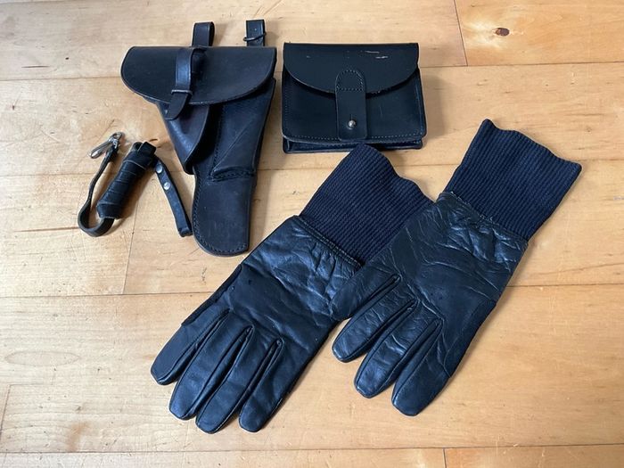 Vintage military-style black leather gear, likely representing a pistol holster, ammunition pouch