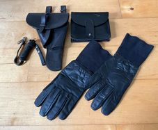 Vintage military-style black leather gear, likely representing a pistol holster, ammunition pouch