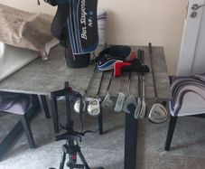 Kids golf clubs and bag and trolley.