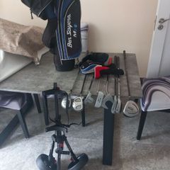 Kids golf clubs and bag and trolley.
