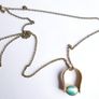 Vintage necklace features a polished, knocker-shaped pendant  gold plated, centered with an iridescent turquoise Spinning Fob Image 8