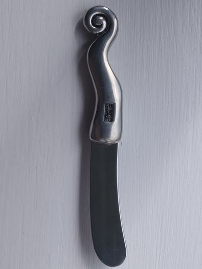 A collectible knife made of polished pewter with a stainless steel blade from Carrol Boyes.