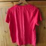 red Adidas t-shirt features a prominent white logo on the chest. Great condition. Image 2