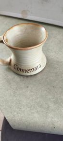Connemara Pottery Irish stoneware mug with a cream glaze and brown rim