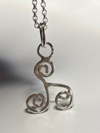 Sterling silver Triskele pendant on 18 or 20 inch chain.