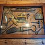 vintage shadow box containing a mix of antique tools, keys, and a loom. Image 6