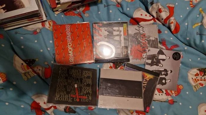 bag of U2 promo CD singles, CD albums and DVD sets