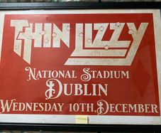 A very large framed print advertising Thin Lizzy