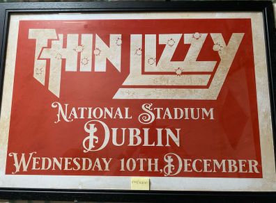 A very large framed print advertising Thin Lizzy