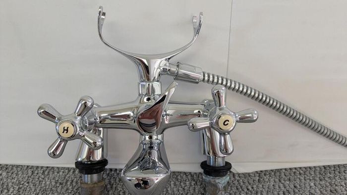 Retro bath mixer with handheld shower head.
