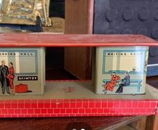 A tin plate Brimtoy painted metal model railroad station platform