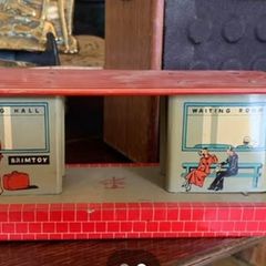 A tin plate Brimtoy painted metal model railroad station platform