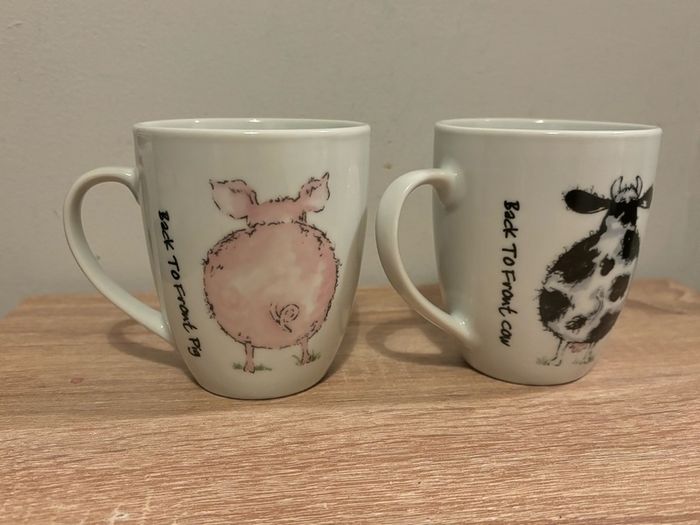 A Pair of Porcelain Cow and Pig Mugs