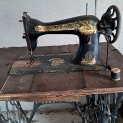 Sewing machine and base