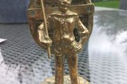 Heavy solid brass sailor with boat on back, 1979, D18 post 10e