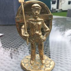 Heavy solid brass sailor with boat on back, 1979, D18 post 10e