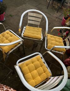 Set of matching patio chairs and four yellow seat pads