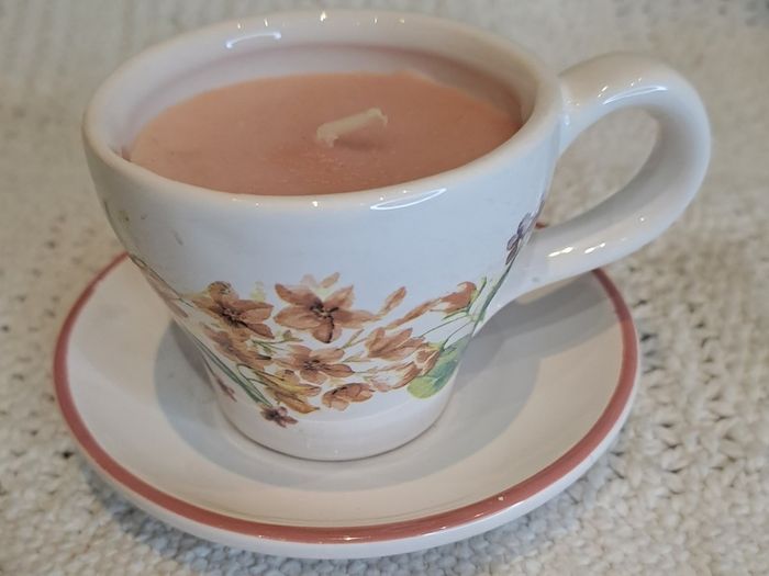 Miniature vintage teacup and saucer with candle